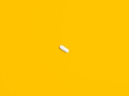 White Pill on Yellow Surface