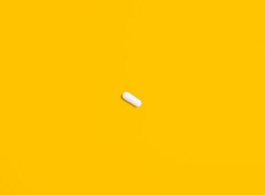 White Pill on Yellow Surface