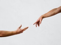 persons hand on white wall