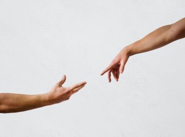 persons hand on white wall