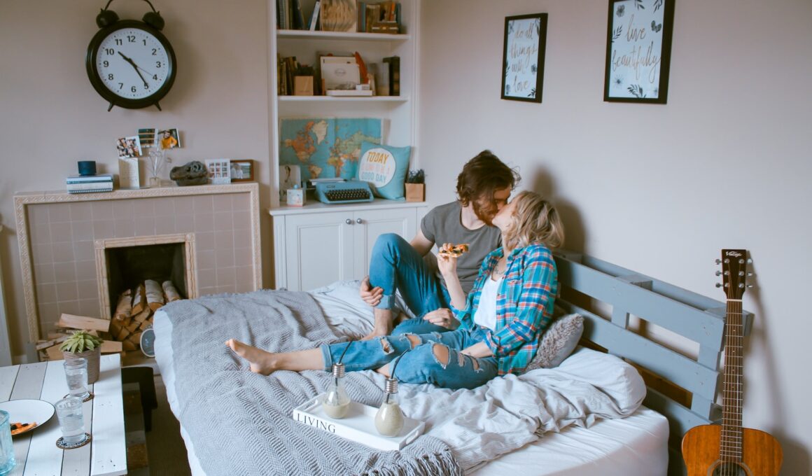 man and woman kissing on bed