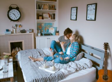 man and woman kissing on bed