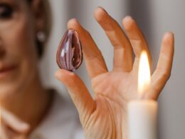 Person Holding Lighted Candle in Front of Person