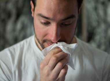 man wiping mouse with tissue paper