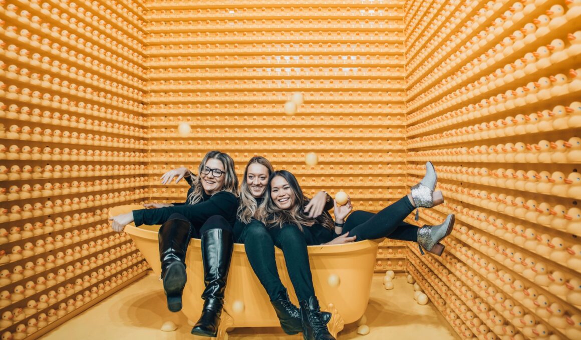 three women sitting inside bathtub