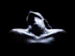 topless woman with black background