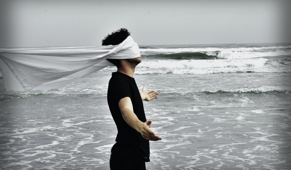 man standing on seashore during daytime