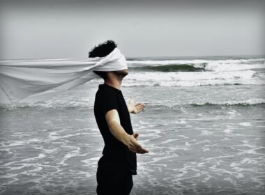 man standing on seashore during daytime