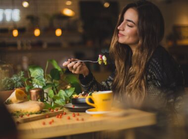 woman holding fork in front table