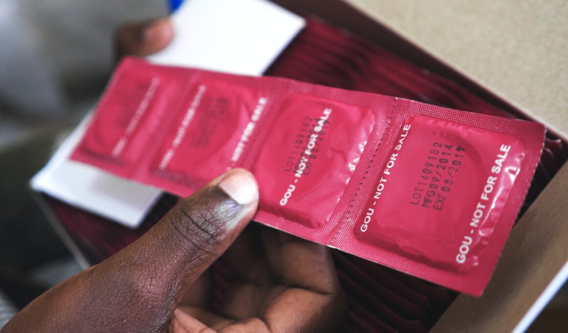 man holding red condom packs