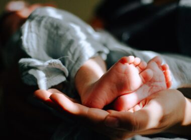 person holding baby feet