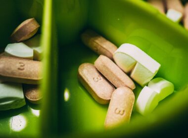 white medication pill on green plastic container