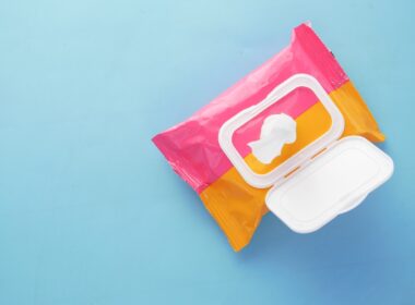 a pink and yellow bag of food on a blue surface