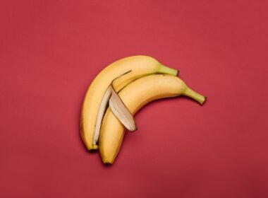 yellow banana fruit on red textile