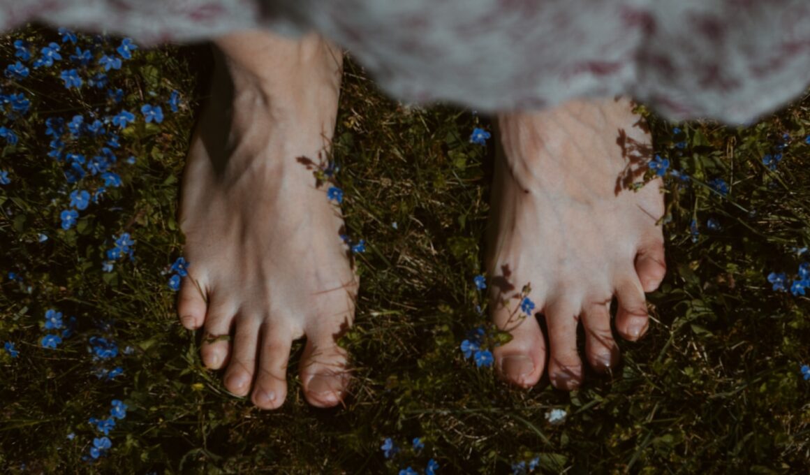 persons feet on green grass